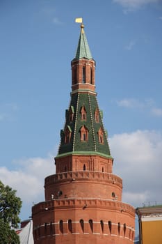 The Angle Arsenal tower (Arsenalnaya Tower) of Kremlin wall over blue cloudy sky, Moscow, Russia