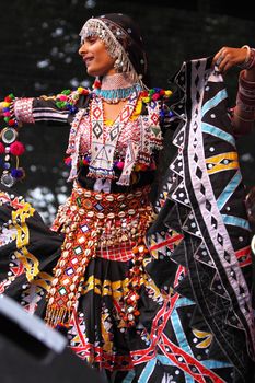 BRISTOL, ENGLAND - JULY 31: Dancer with the Jaipur Kawa brass band performing at the Harbour Festival in Bristol, England on July 31, 2010. Founded in 1971, this free three day event played host to more than 250,000 spectators