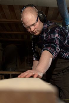 male carpenter engaged in the production of grinding bar