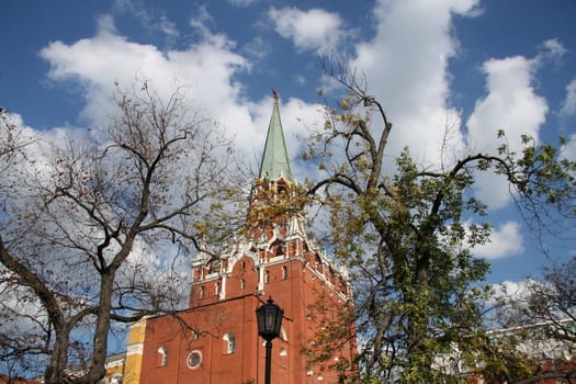 Moscow Kremlin view from Alexandrovsky garden.  Troitskaya tower over blue cloudy sky, Moscow, Russia