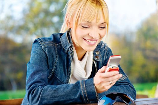 Blond woman at park taking a phone call