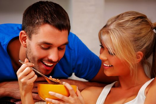 bright picture of happy couple with muesli (focus on man)