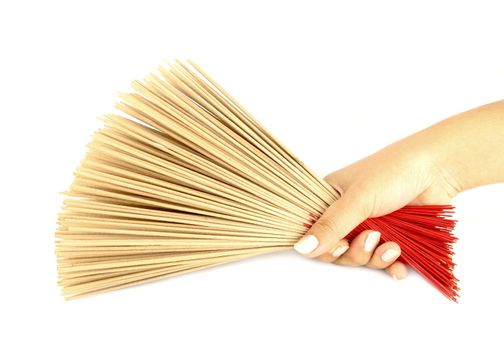 hand holding incense on white background