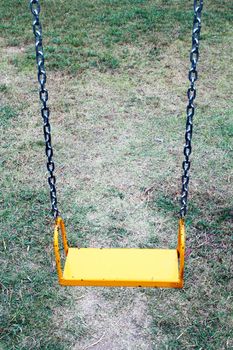 yellow garden swing hanging in garden