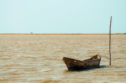 A lone canoe on a lagoon in La Guajira, Colombia