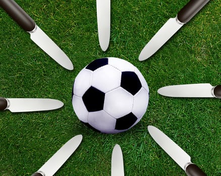 Football sport, soccer ball on grassland and knife around.