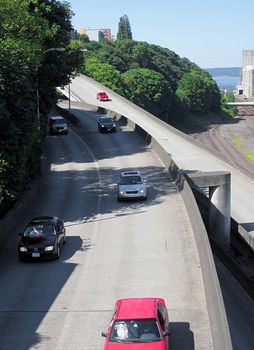 A photograph of city traffic near a waterway.