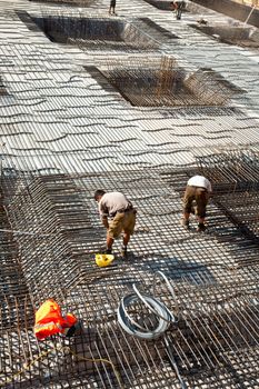 workers are doing the armoring at the building site to stabilize the fundament