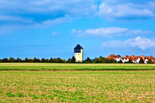 settlement beside an old watertower