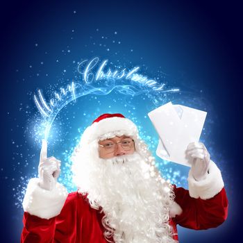 Santa holding Christmas letters and looking at camera