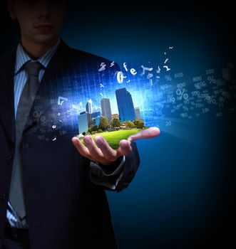 Image of a modern cityscape in the hand of a businessman