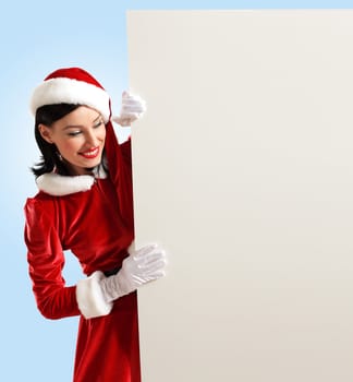 Portrait of a santa girl with a blank banner