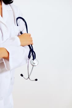 Portrait of happy successful young female doctor holding a stethoscope