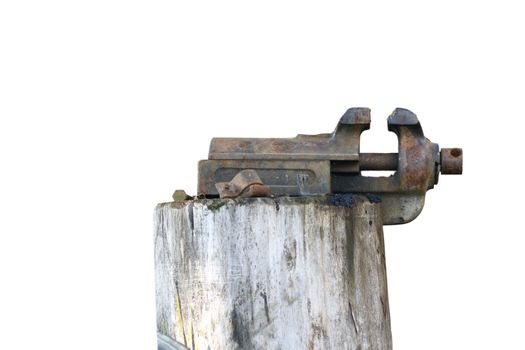 old rusty vise mounted on a spruce stump isolated over white background