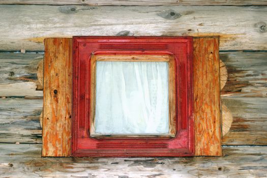 exterior view of a small wooden window on the facade of a lodge