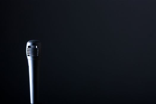 the single microphone on the dark background