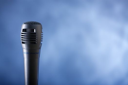 the single microphone on the blue background