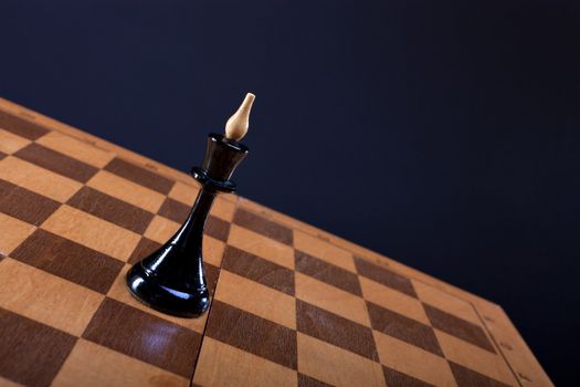 chess queen on the Board dark background