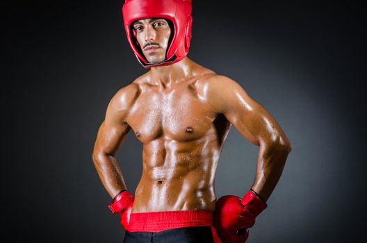Muscular boxer in dark studio