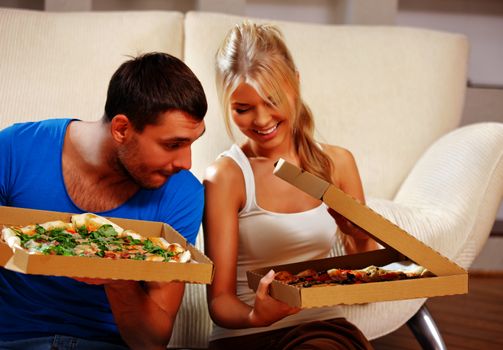 picture of happy romantic couple eating pizza at home (focus on man)