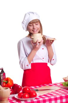 beautiful woman looking into a pot of food, cooking vegetables