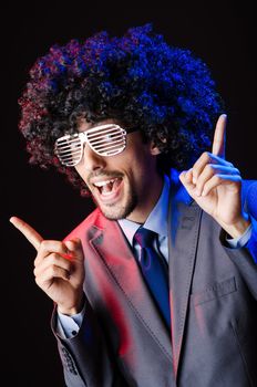 Singer with afro cut in dark studio