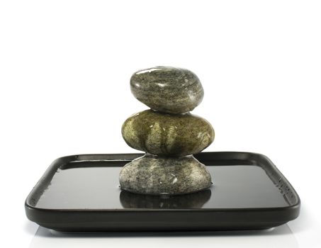 three stones in balance with water