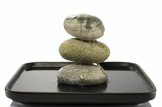 three stones in balance with water