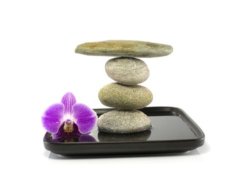 stones and orchid in balance on water