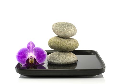 stones and orchid in balance on water