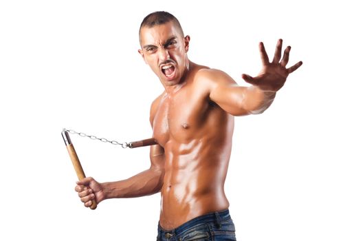 Man in martial arts concept with nunchucks