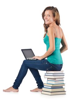 Student with netbook sitting on books