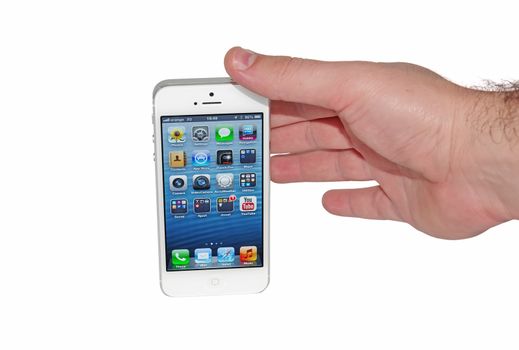 Hand taking the new Apple iPhone 5 with on a white background