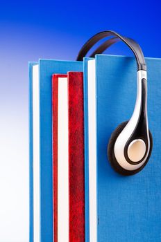 Concept of audio books with earphones on white