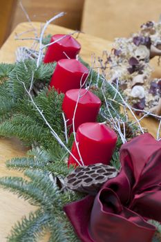 A Christmas decoration with four big red candles