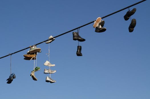 Shoes hanging on a cable