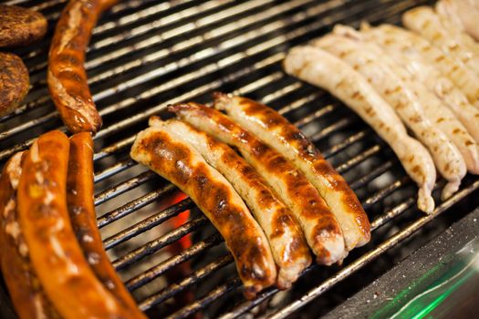 German sausages being grilled over coal outdoors