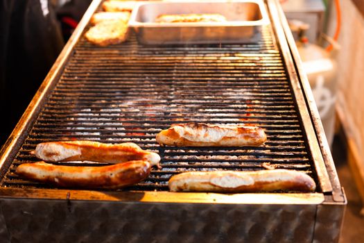 German sausages being grilled over coal outdoors