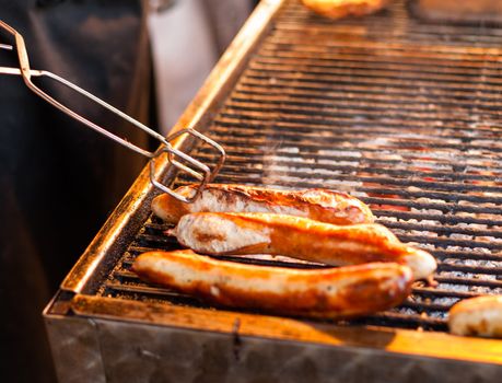 German sausages being grilled over coal outdoors