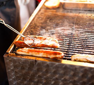 German sausages being grilled over coal outdoors