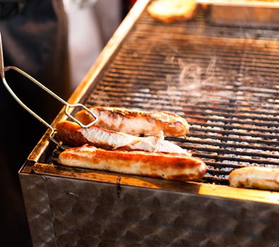 German sausages being grilled over coal outdoors