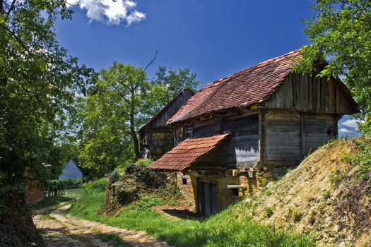 Rural village of Zaistovec in Croatia, with wooden cottages - wine cellars and dirt road