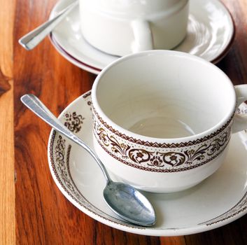 An empty cup of coffee on a wooden table