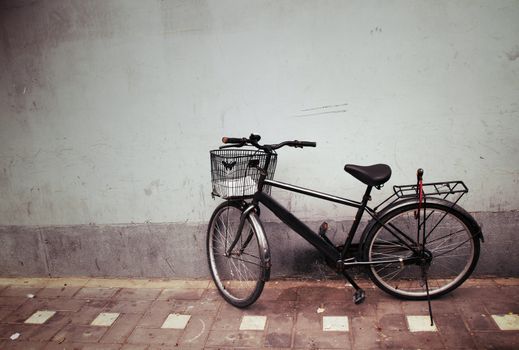 Old Bicycle against a Wall