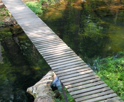 wooden walkway path on stream