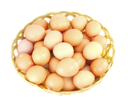 Brown eggs in the basket on white