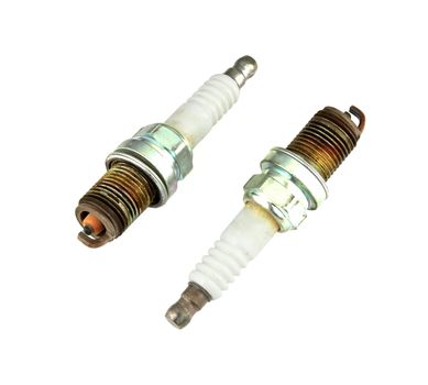 two old burned spark plug on white background