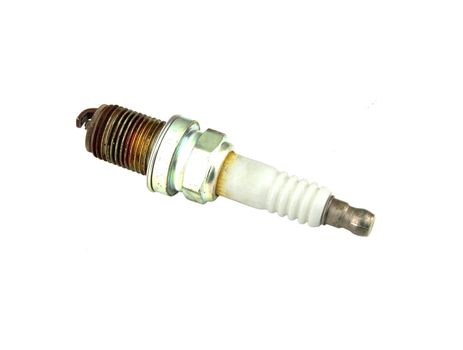 old burned spark plug on white background