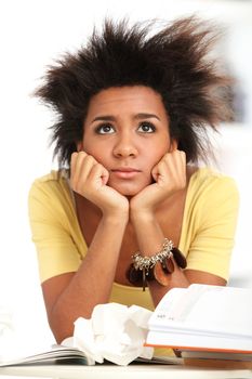 Young black woman tired from studying with books