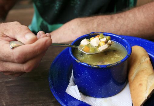 Vegetable soup in a dark blue cup